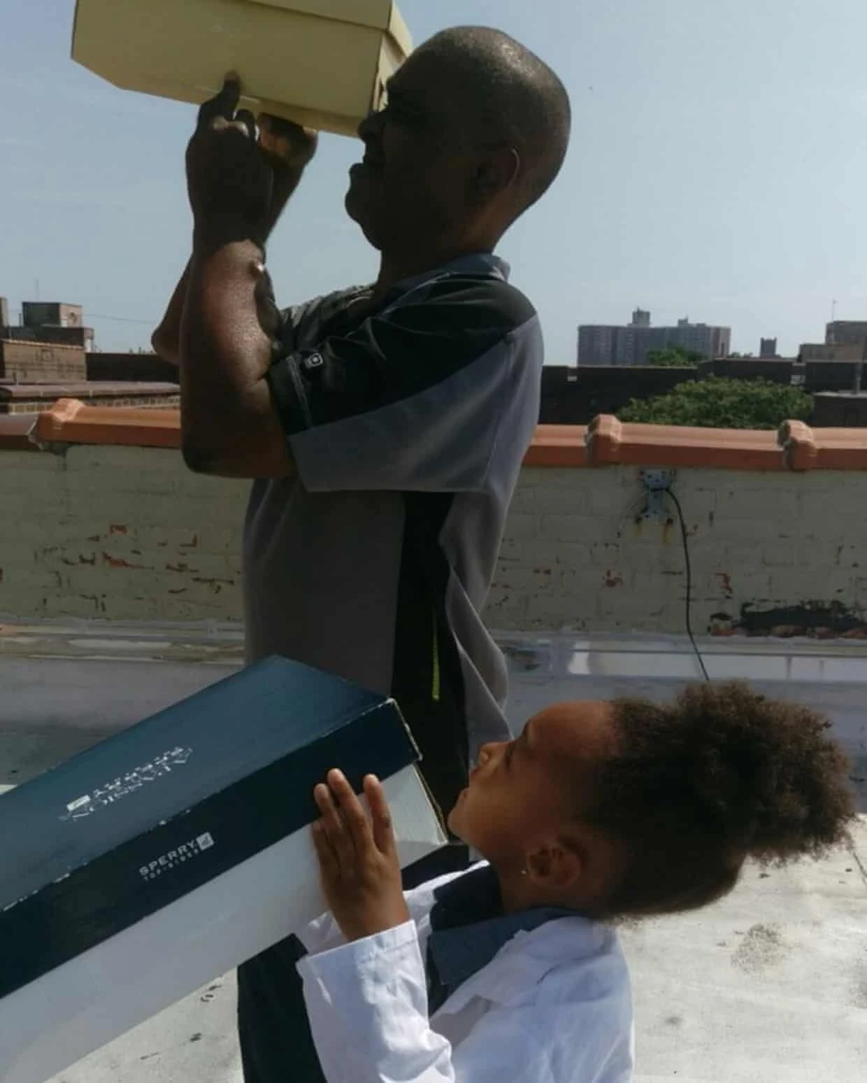 Melanie Keaton and her grandfather look through shoe boxes during a 2017 solar eclipse.