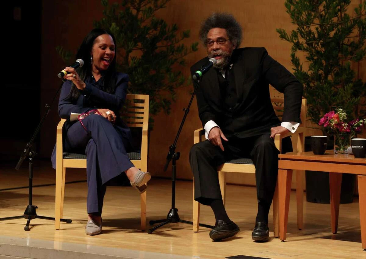 Cornel West (right) sits with Director Sheryl Evans Davis of the San Francisco Human Rights Commission as she moderates 'Dreaming Forward: A Year in Review' at the San Francisco Public Library's Koret Auditorium .