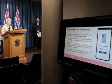 Premier John Horgan watches Provincial Health Officer Dr. Bonnie Henry discuss plans for the BC Vaccine Card, a digital or printed document that shows the stage cardholders are at in the progress of their vaccine against COVID-19. [PNG Merlin Archive]