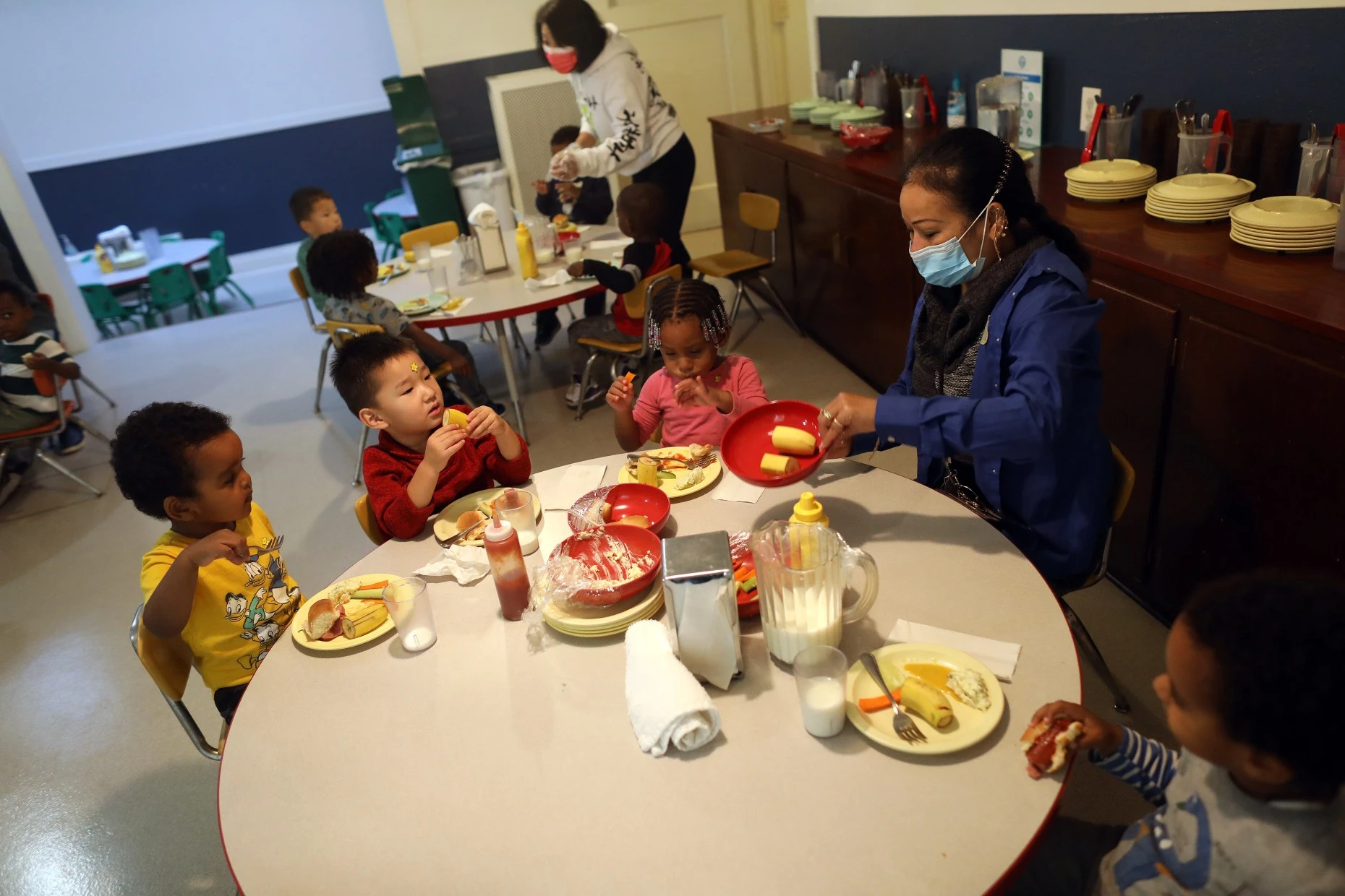 Preschool students eat lunch in the dining hall at Saint Vincent's Day Home on Tuesday, Oct. 11, 2022 in Oakland, Calif.  The house was founded by the Sisters of the Holy Family in 1911 and offers educational courses, childcare and other services.  for low income families.  (Aric Crabb/Bay Area News Group)